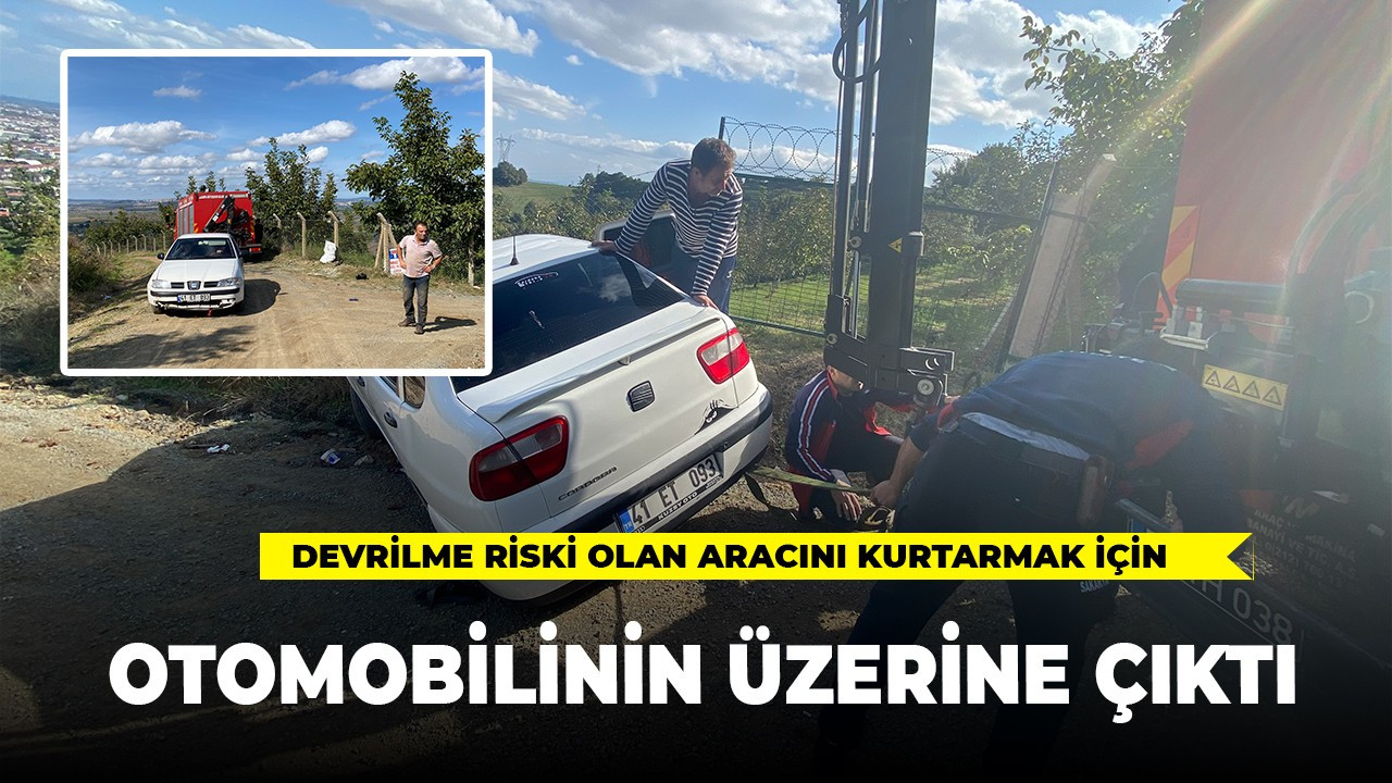 Devrilme riski olan otomobilini kurtarmak için üzerine çıktı